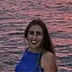 Serena Cuomo smiling with the sunset sea background, guest relations manager specializing in bespoke itineraries for Amalfi Coast private boat charters